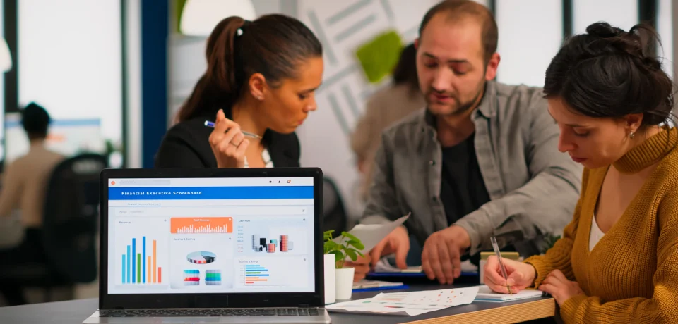 Marketing team reviewing analytics dashboard to plan market campaigns for a business